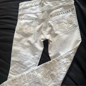 White embroidered skinny jeans with silver studs
